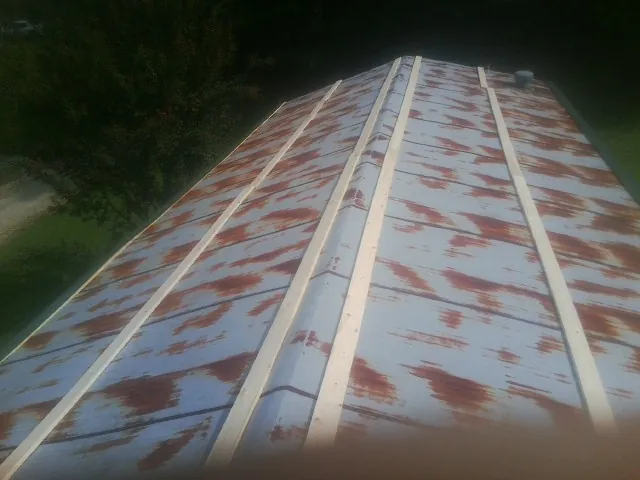 Rusted metal roof panels with new wood purlins before replacement — Storm Damage Roof Repair in Elk Creek by Roofing Brothers