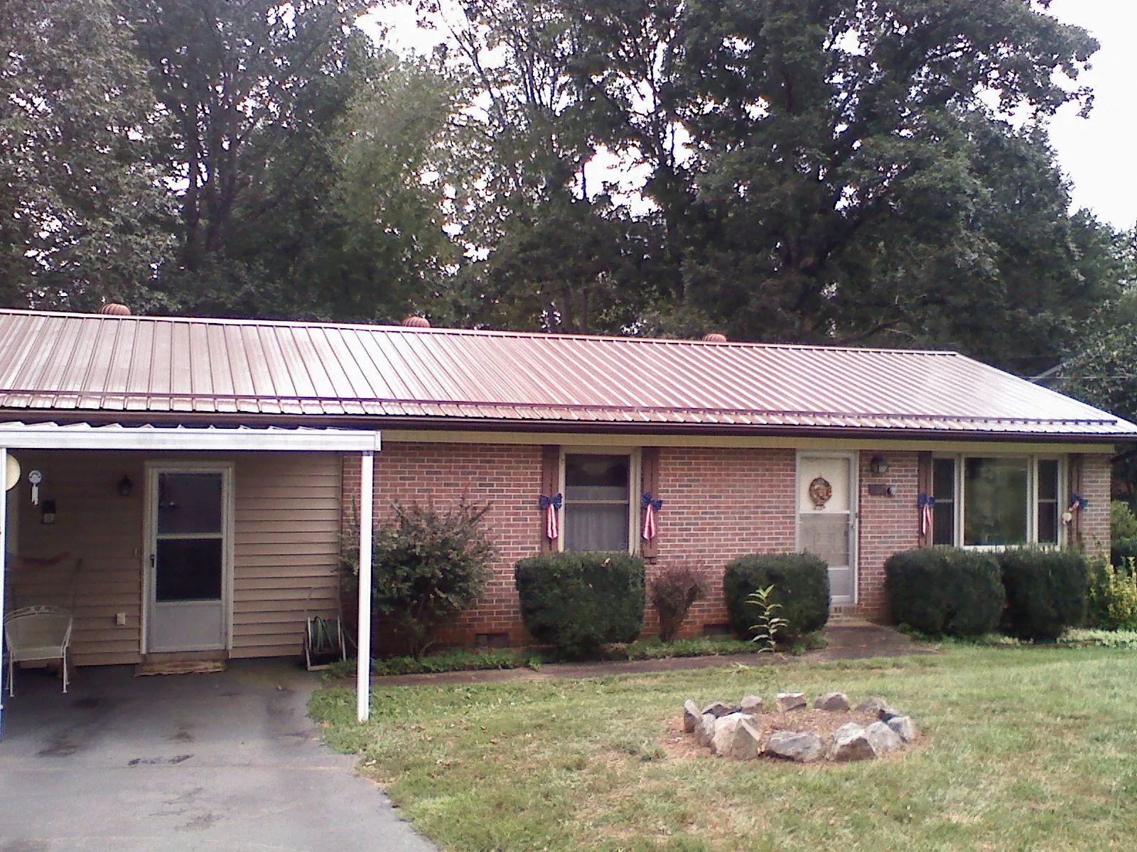 Bronze metal roof and carport on a brick ranch home — Roof Repair work by our crew in Elk Creek
